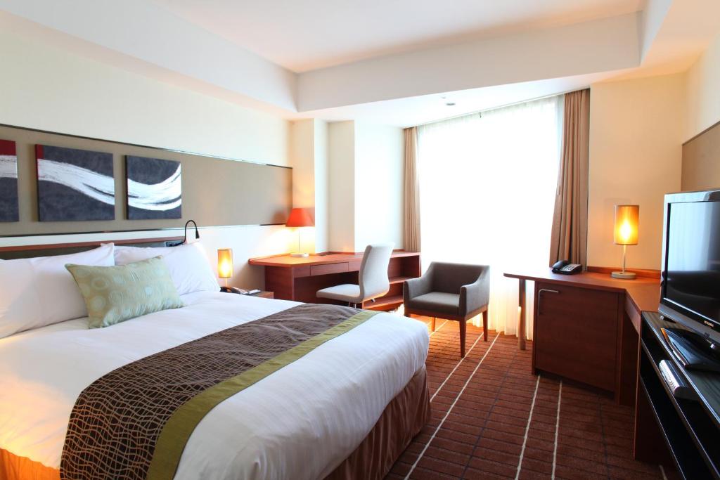 成田International Resort Hotel Yurakujo的酒店客房,配有床和电视