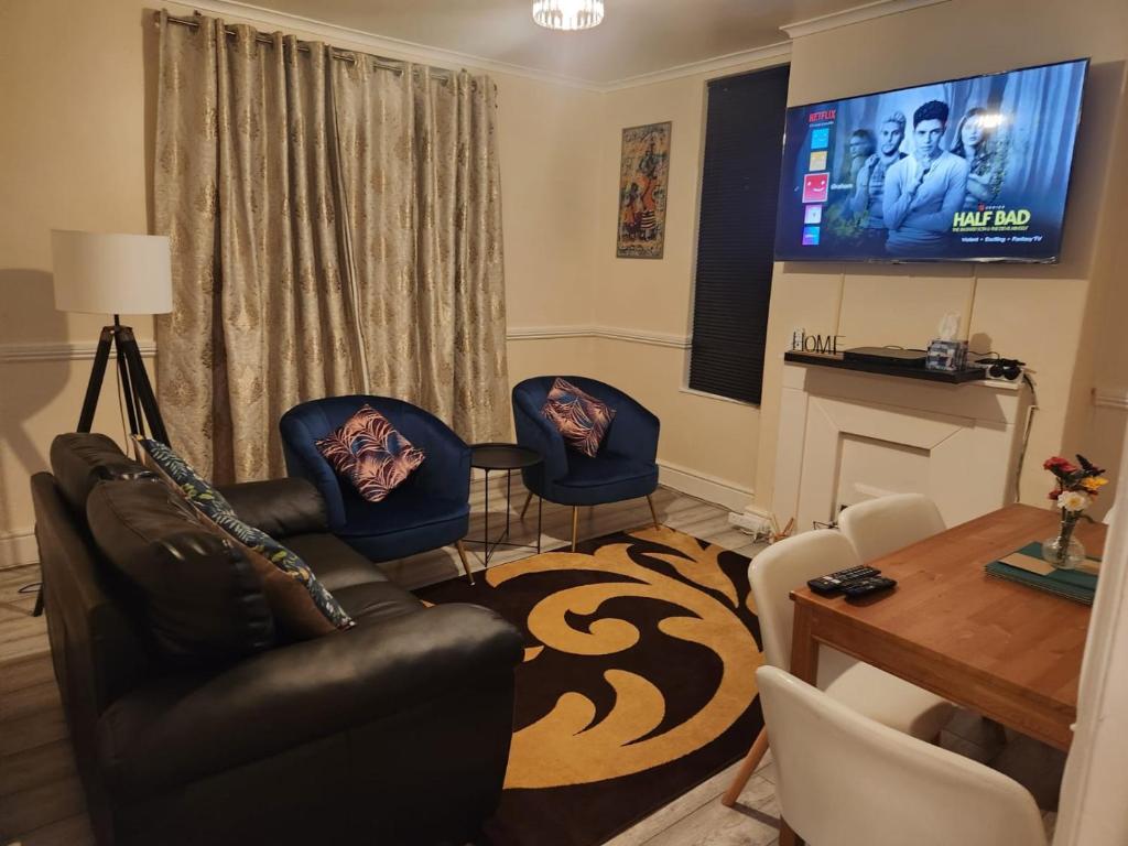 伦敦2-bedroom flat in Cutty-Sark, Greenwich !的客厅配有沙发、椅子和电视