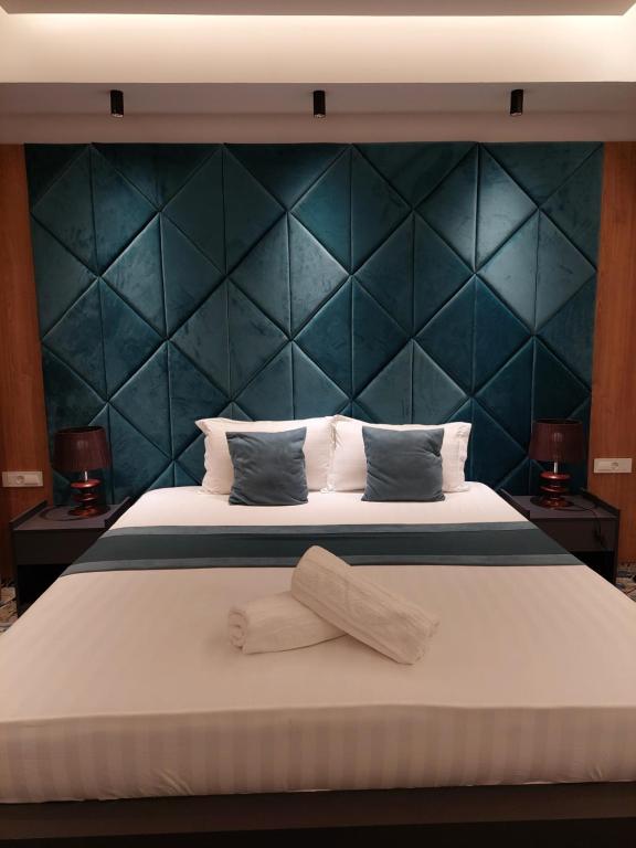 盖夫盖利亚Apartments Jordan Luxury的一间卧室配有一张大床和蓝色床头板