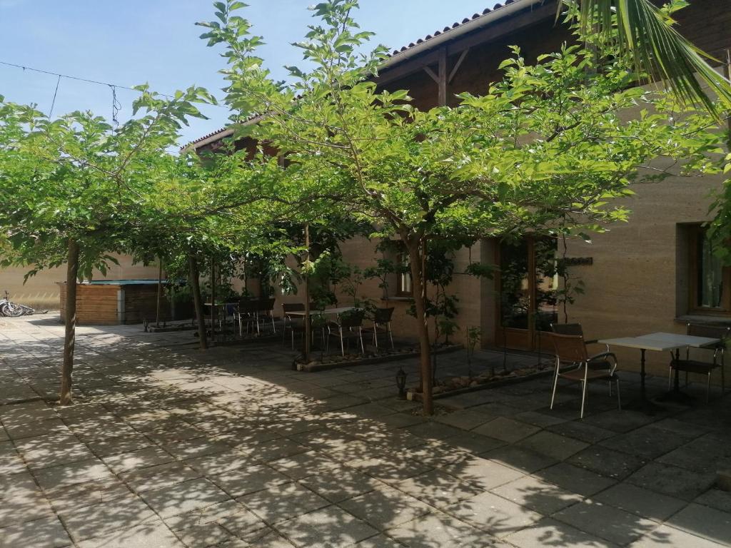 Théziers克洛斯博伊西住宿加早餐旅馆的庭院里种有树木,配有桌椅