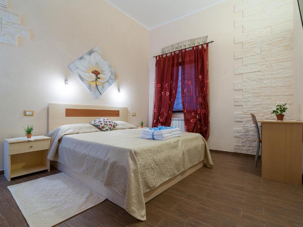 卡利亚里Il Borgo的一间卧室配有床和红色窗帘