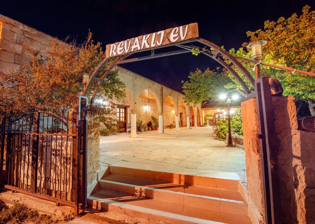 RizokarpasoRevaklı Ev Guest House的建筑物前有路标的大门