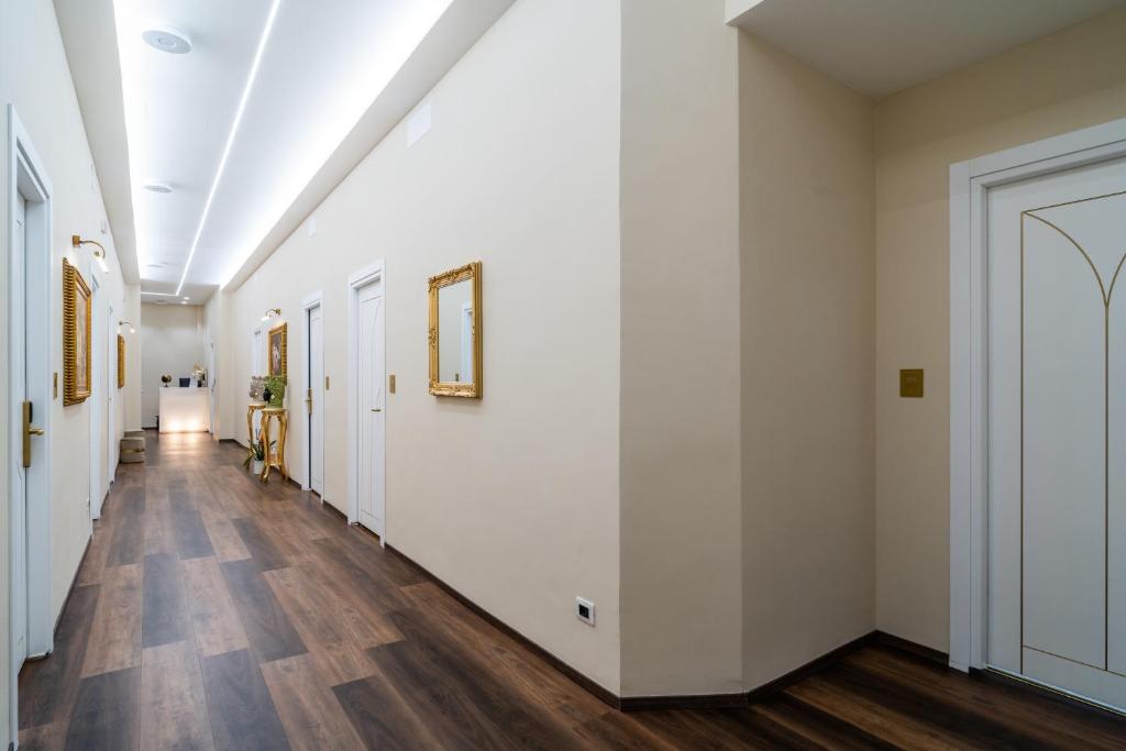 圣雷莫Correnti Boutique Hotel Gold的空的走廊,有白色的墙壁和木地板