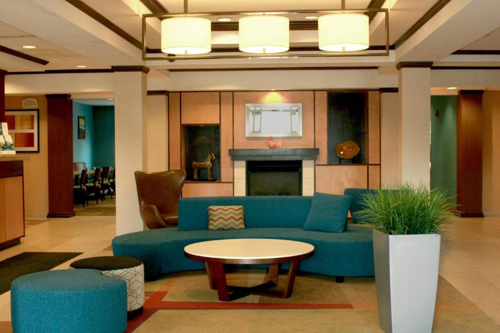 费尔蒙特Fairfield Inn & Suites by Marriott Fairmont的客厅配有蓝色的沙发和桌子