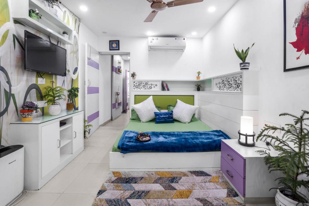 新德里Homlee-Heritage 2-Bed Room Apt near Pragati Maidan的一间设有床铺和电视的房间