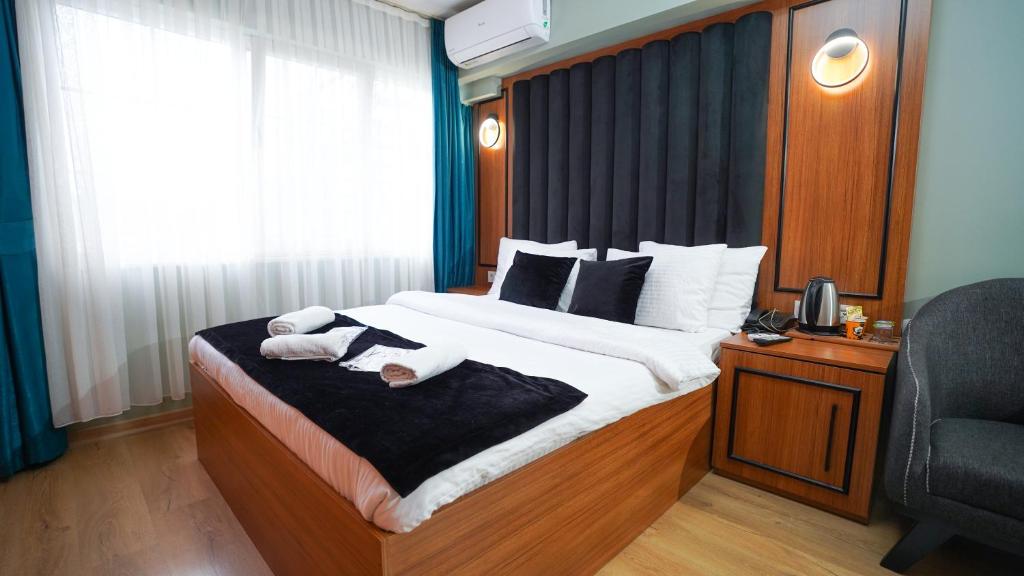 伊斯坦布尔Lukka Suit Hotel的一间卧室配有一张大床和毛巾