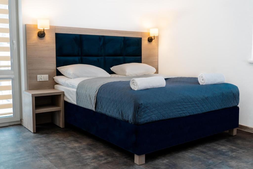 下乌斯奇基Lynks Resort的一间卧室配有一张大蓝色的床和两个枕头