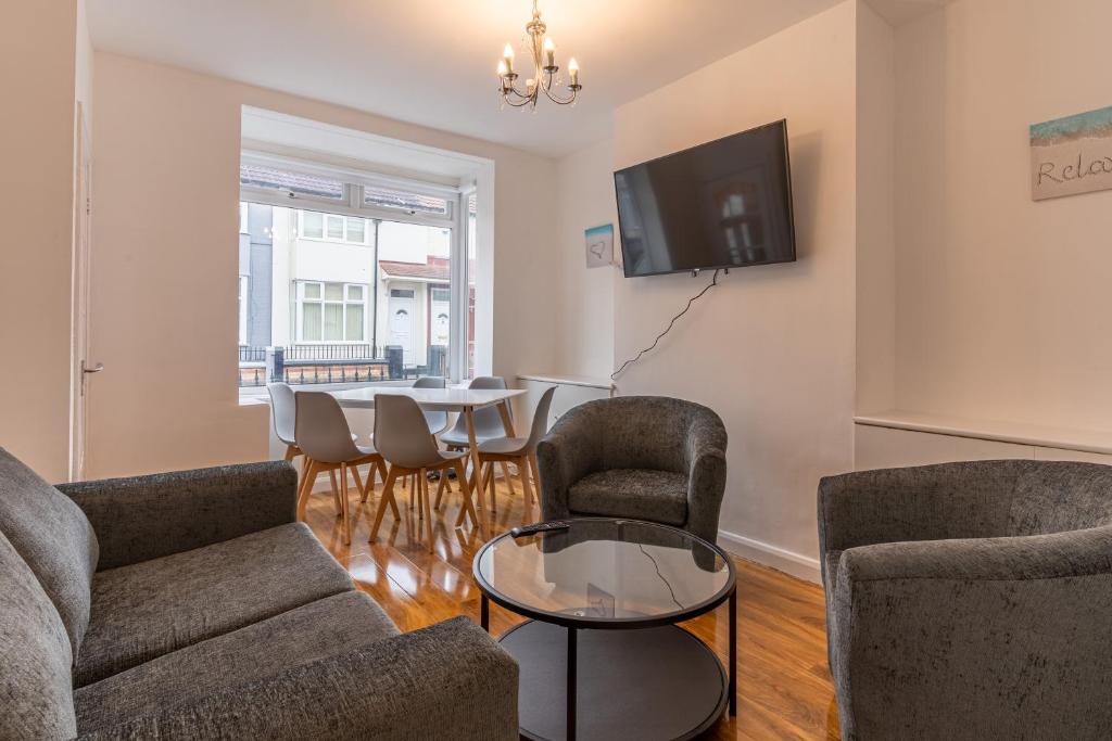 利物浦Cheerful and modern 3 BDR for 7的客厅配有沙发、椅子和桌子