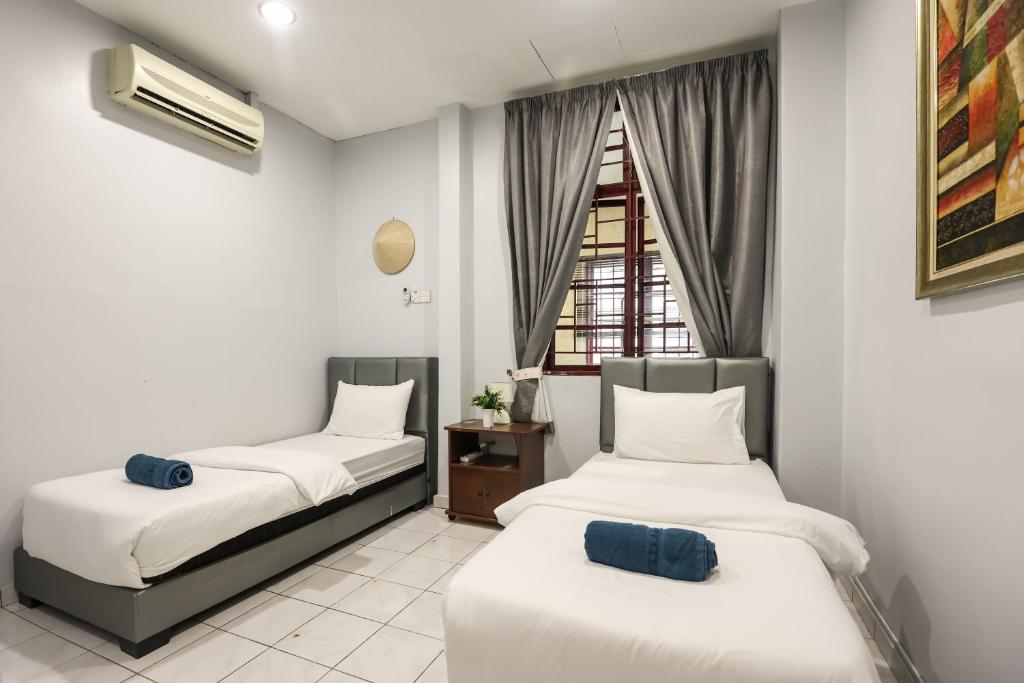 八打灵再也Kota Damansara ICozy Cove Homestay 10 Pax的带窗户的客房内的两张床
