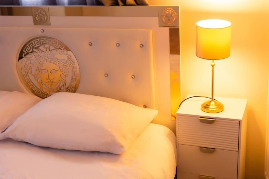 布里地区叙西Belle maison Paris/Disney的一间卧室,配有一张带台灯的床头柜