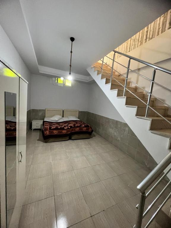 Çiftlikköyİmperium的一间卧室设有一张床和一个楼梯