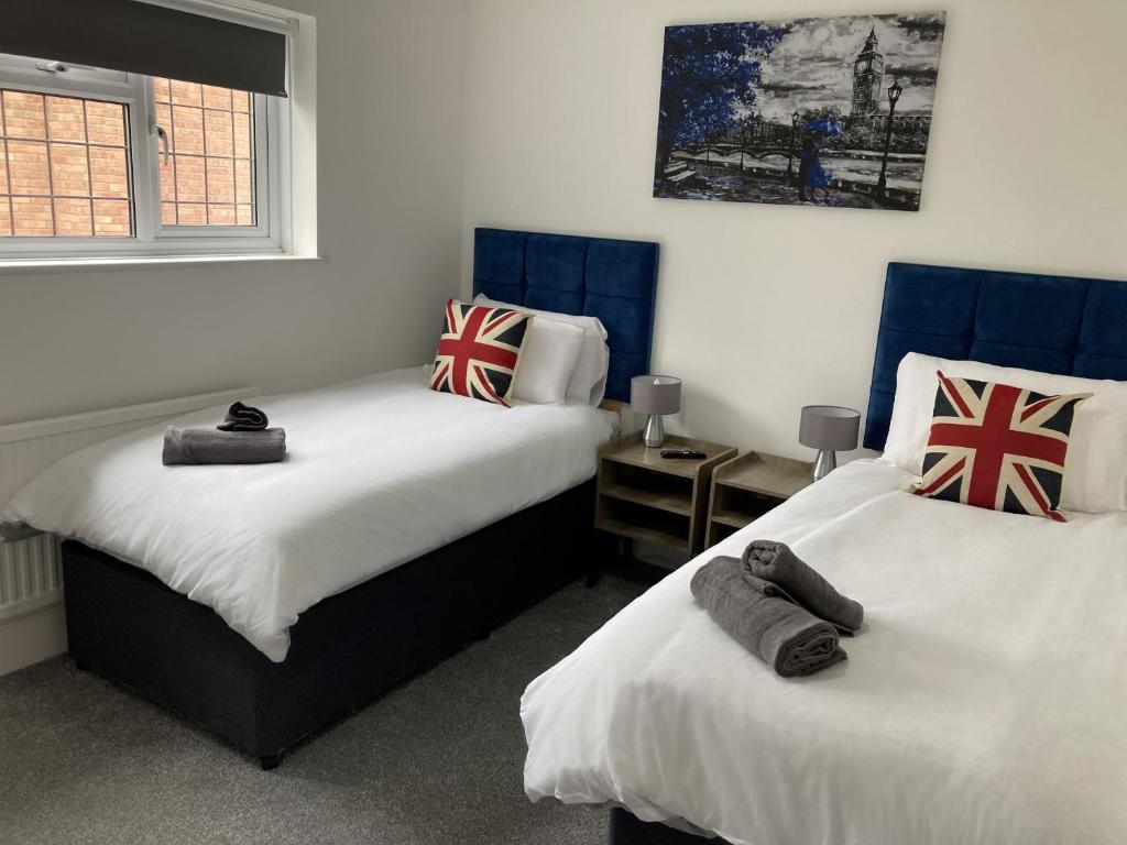 布伦特伍德Brackens的一间卧室配有两张带英国国旗的床。