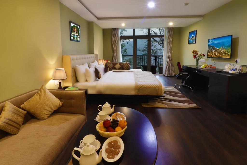 甘托克Five Gangtok的酒店客房配有床、沙发和桌子。