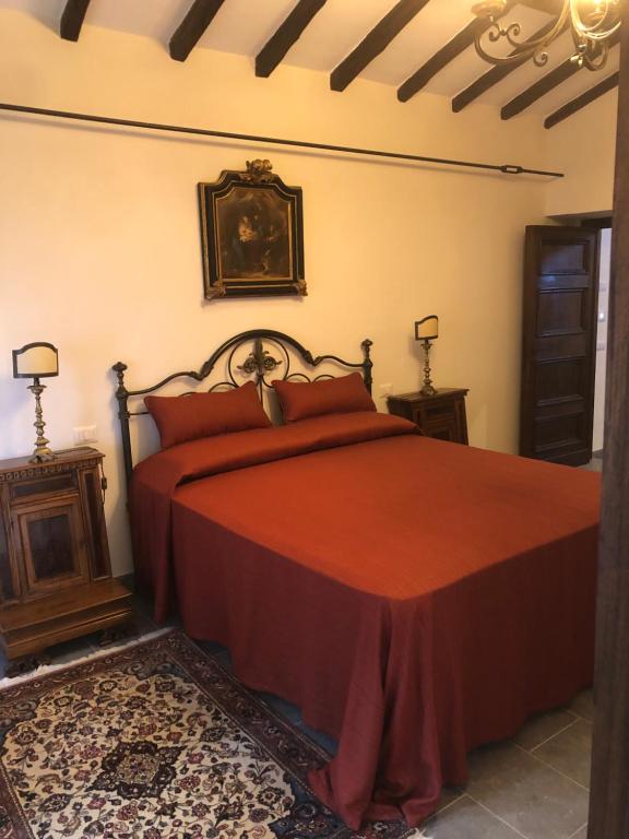 韦特拉拉Il Rifugio del Vescovo的一间卧室配有红色的床和2个床头柜