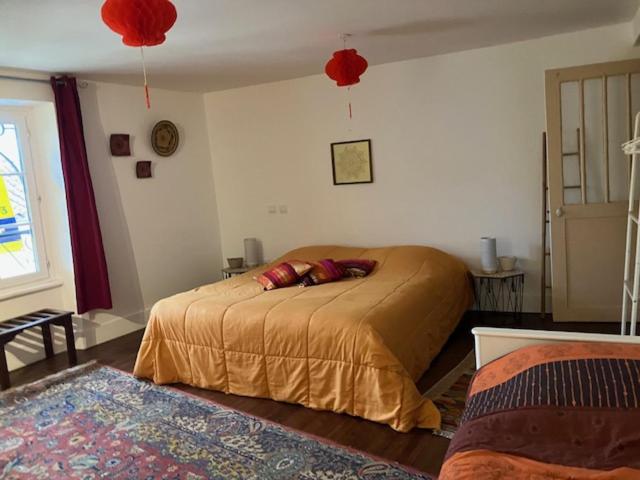 Saint-SeverLe Cazalet的一间卧室配有一张带红色枕头的床