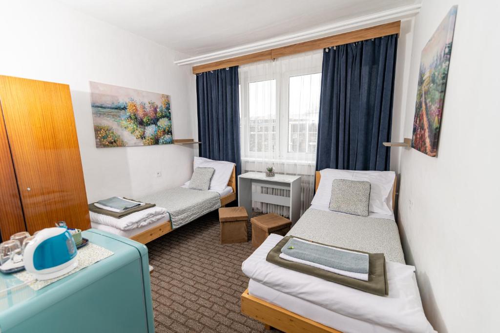 利普托斯基米库拉斯Turistická ubytovňa的酒店客房,设有两张床和一张沙发