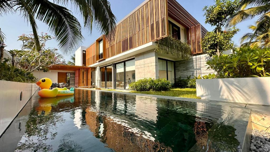 富国West Phu Quoc Charm 3BR private pool villa的房屋前有游泳池的房子