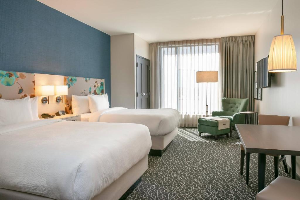 纳什维尔TownePlace Suites Nashville Downtown/Capitol District的酒店客房,配有两张床和椅子