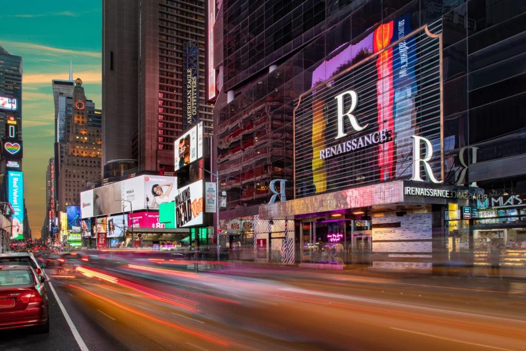 纽约Renaissance New York Times Square Hotel by Marriott的繁忙的城市街道,晚上有楼房和汽车