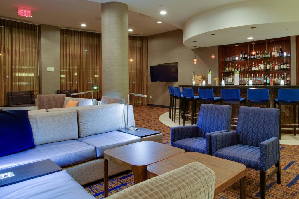 法明代尔长岛/法明代尔共和国机场万怡酒店的带沙发的酒店大堂和酒吧