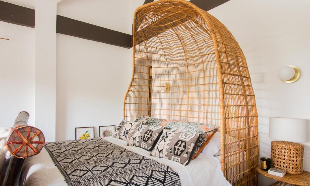 董索Villa Kulintang的一间卧室配有一张带竹床头板的床