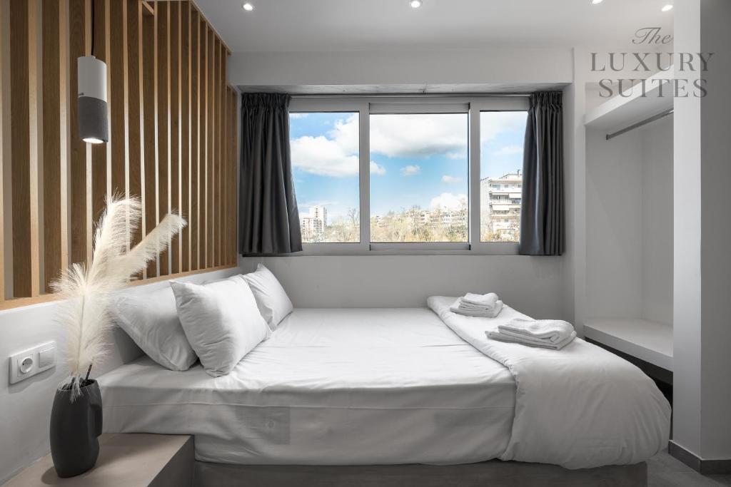 塞萨洛尼基Horizon Apartments, The Luxury Suites的卧室配有一张大白色床和窗户