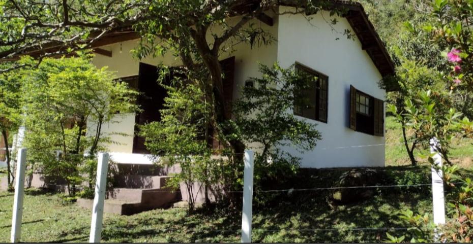 圣路易斯-杜帕赖廷加Casa de Campo no Parque Estadual da Serra do Mar的前面有栅栏的白色房子