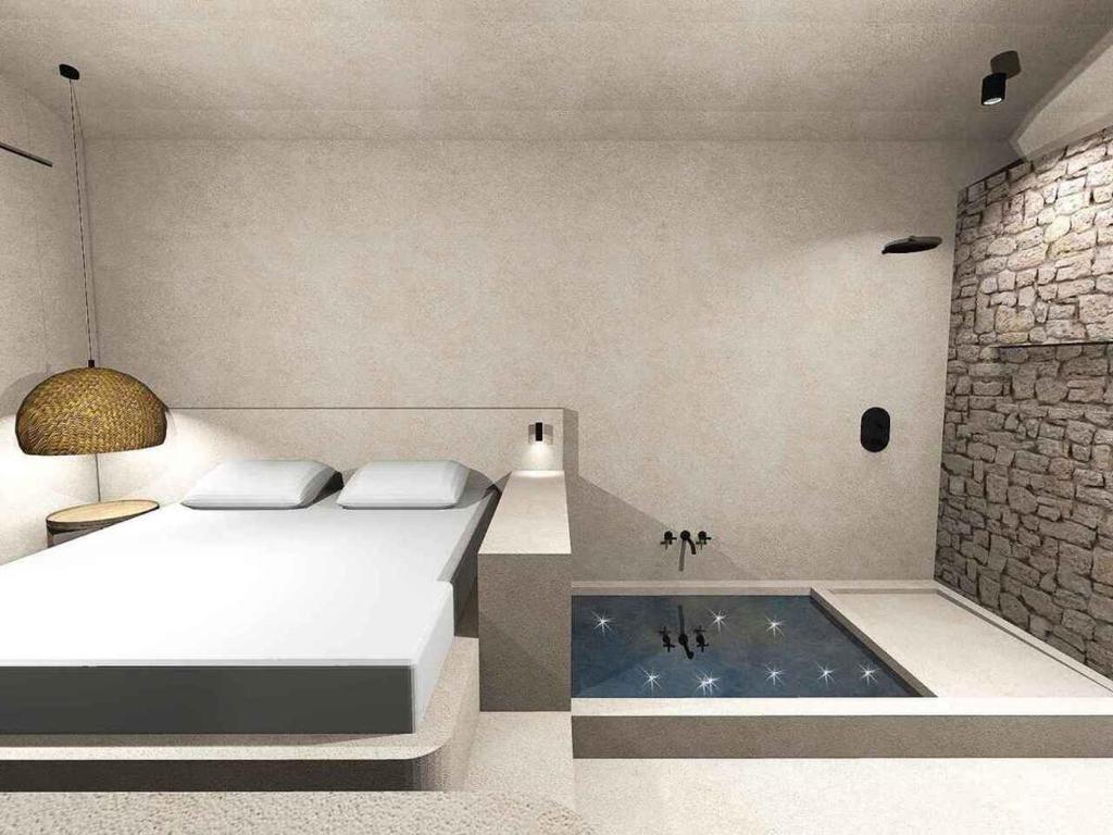 哈尔基岛EliteDIMension Chalki的一间卧室配有一张床和浴缸