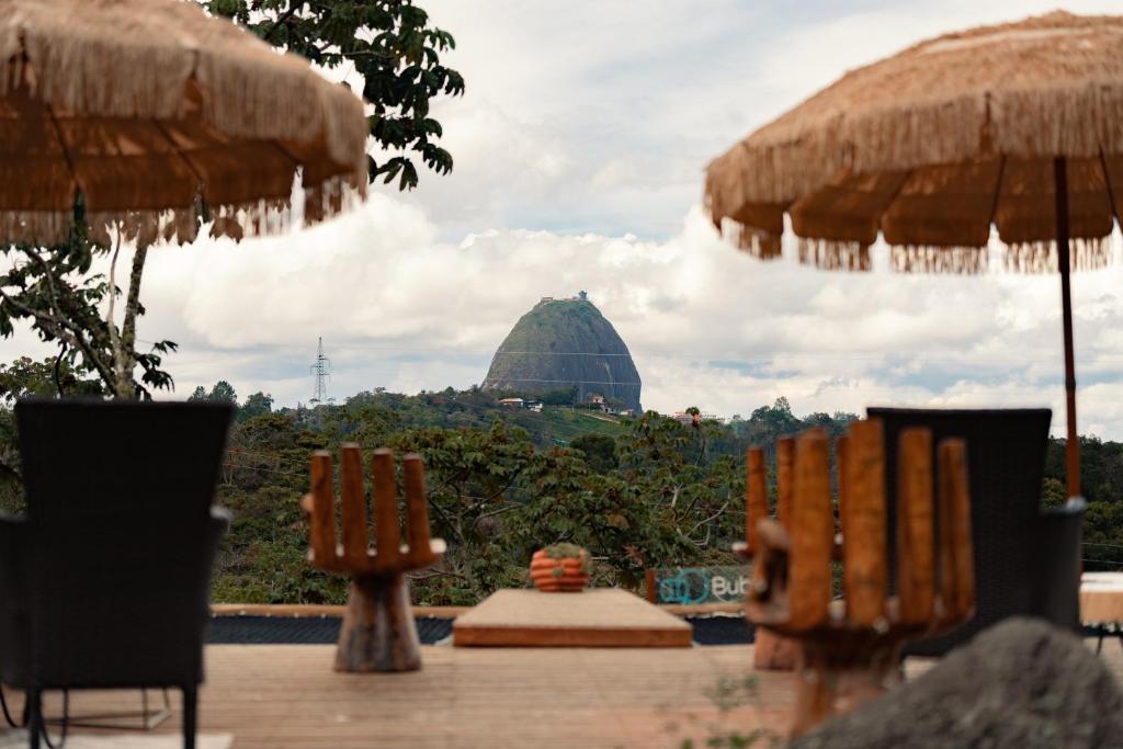 瓜塔佩BubbleSky Glamping Guatapé的远处一座带遮阳伞的建筑的景色