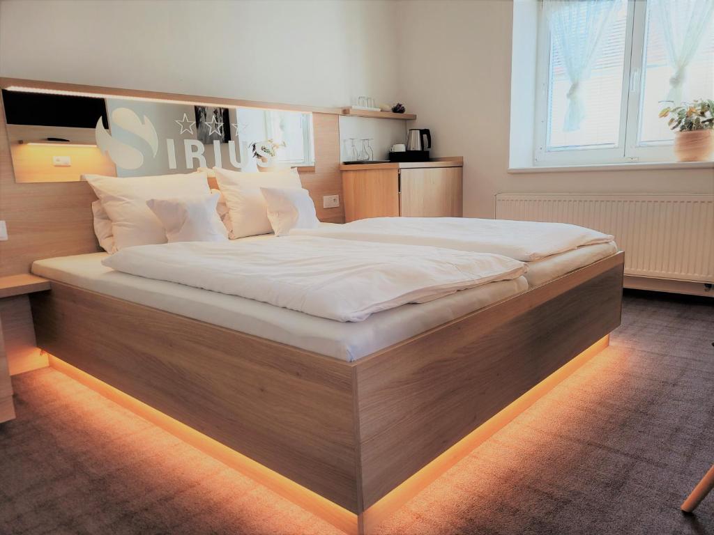 维什科夫天狼星膳食公寓的卧室内的一张带木框的大床