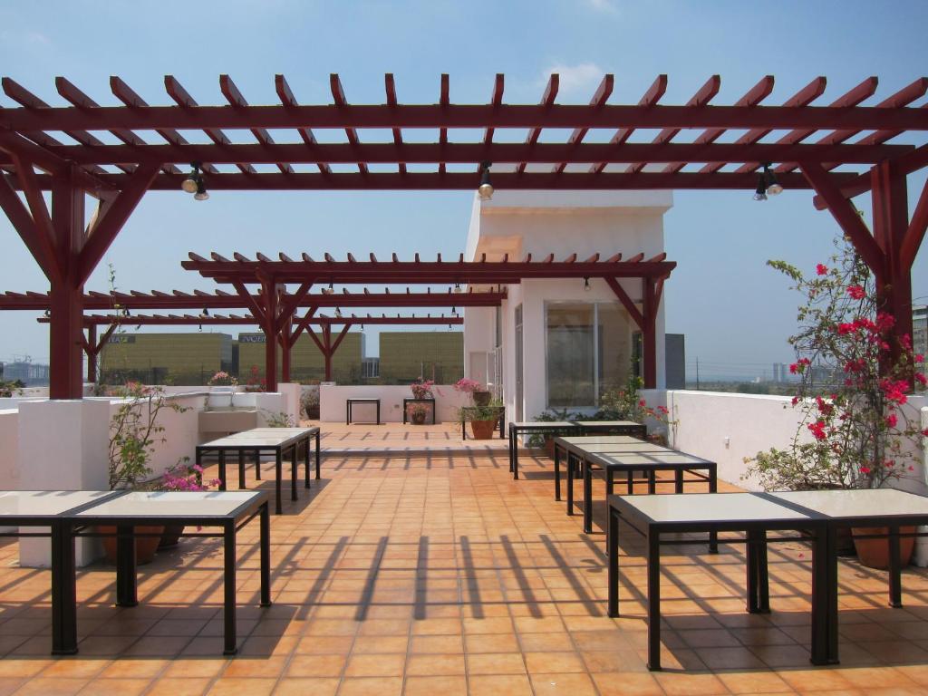 马尼拉尼可尔斯机场酒店的庭院设有野餐桌和木制凉亭