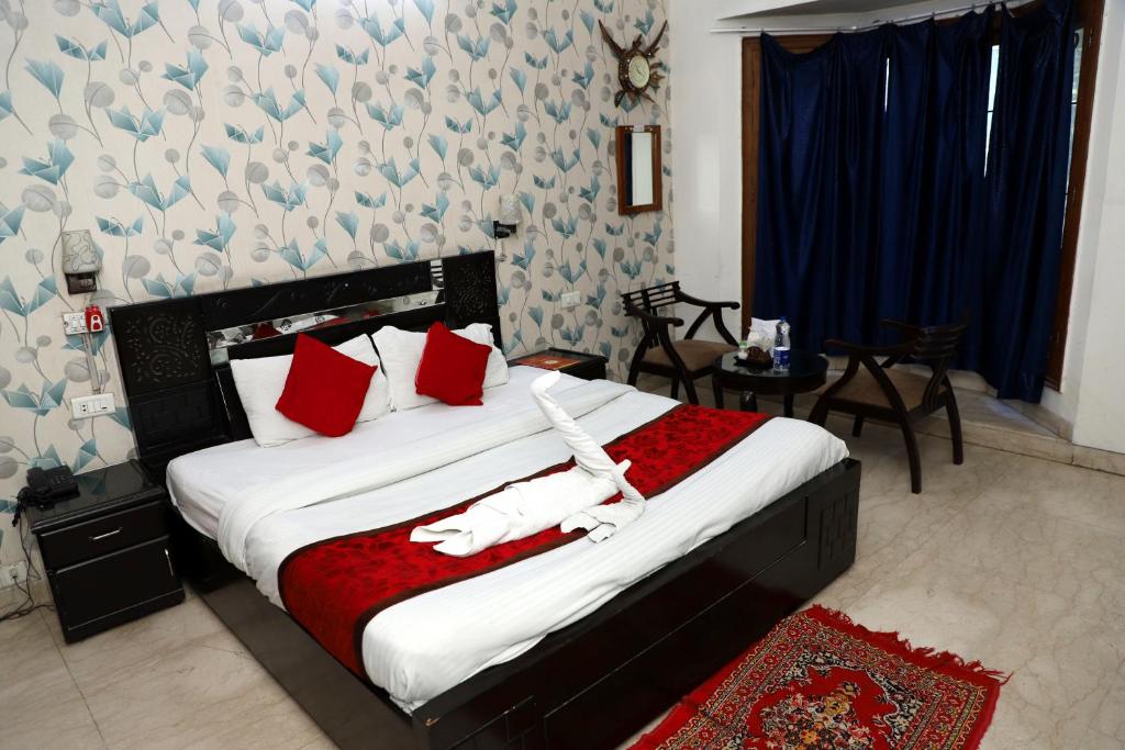 诺伊达Ashray House Noida的一间卧室,床上有两只白鸟
