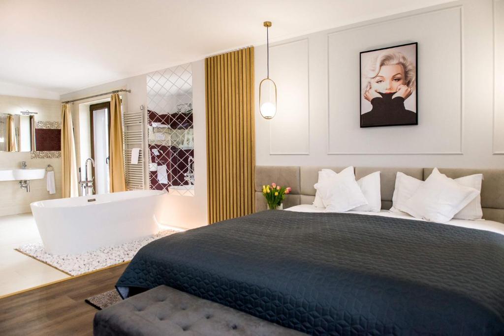 蒂米什瓦拉拉米娜酒店的一间卧室设有一张大床和一个浴缸