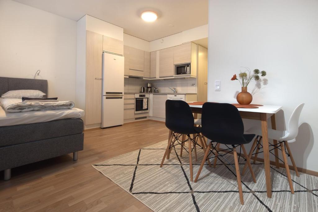 罗瓦涅米First Aparthotel Dasher的厨房以及带桌椅的用餐室。