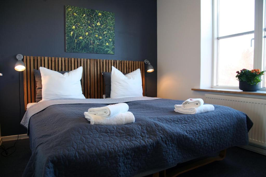 内克瑟Nexø Modern Hostel. Private Rooms的一间卧室配有带毛巾的床