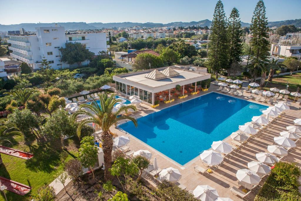 伊利索斯IALYSSOS BAY HOTEL的享有带椅子的游泳池和大楼的空中景致