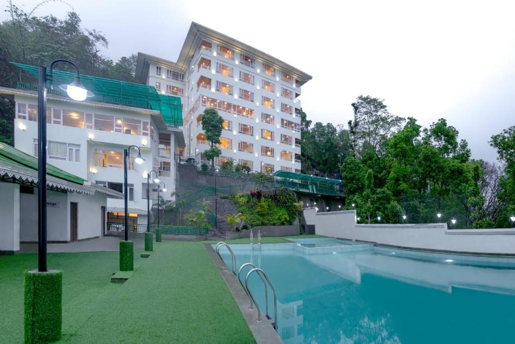 甘托克Treenz Hotel的大楼前设有游泳池的酒店