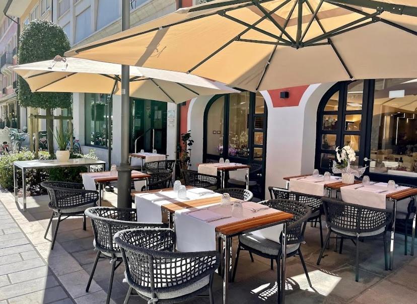 格拉多Ca’ Bruno Masaneta的一间带桌椅和遮阳伞的餐厅