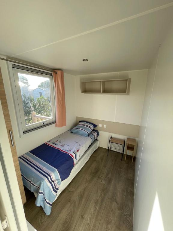 鲁西隆地区卡内Mobil home 6 à 8 personnes SANS Fun Pass的一间小卧室,配有床和窗户