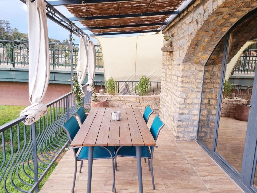 蒙特利马尔La terrasse du Roubion的阳台上的木桌和椅子