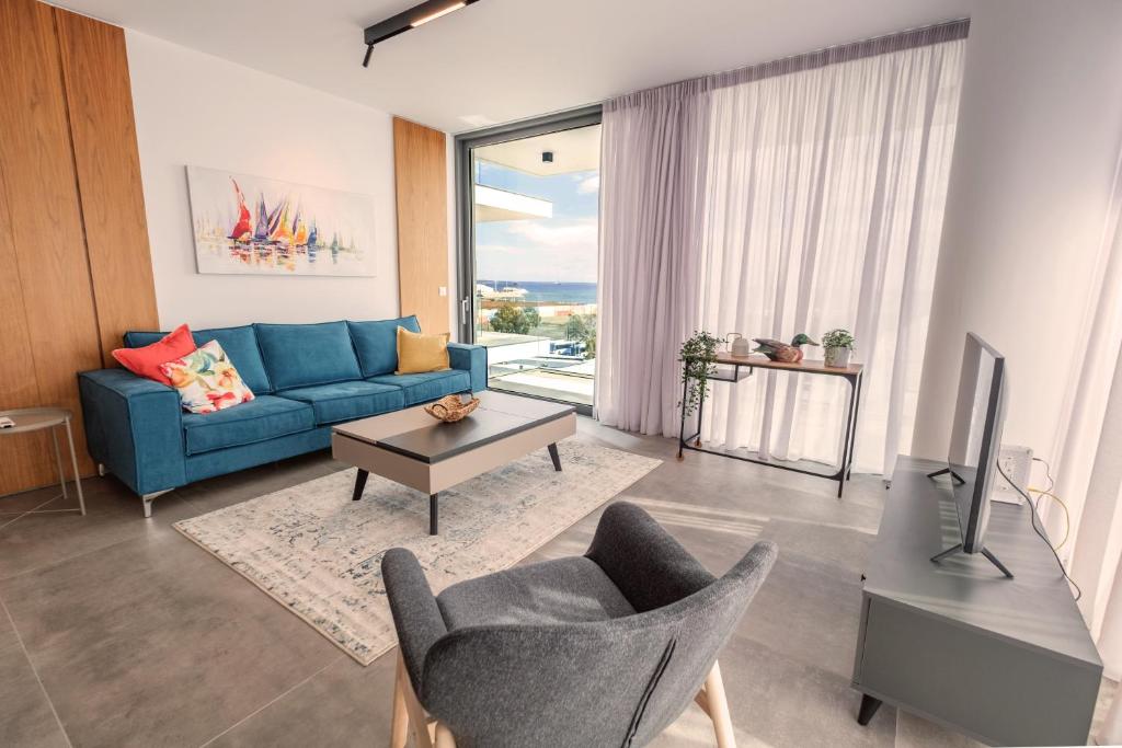 拉纳卡Gaia Seaview Apartment 1的客厅配有蓝色的沙发和电视