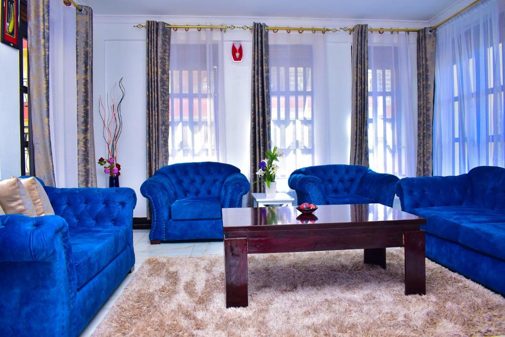 基苏木Rozy Penthouse的客厅配有蓝色的沙发和咖啡桌
