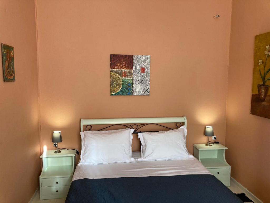 干尼亚Sergios Village House的一间卧室配有一张床、两个床头柜和两盏灯。