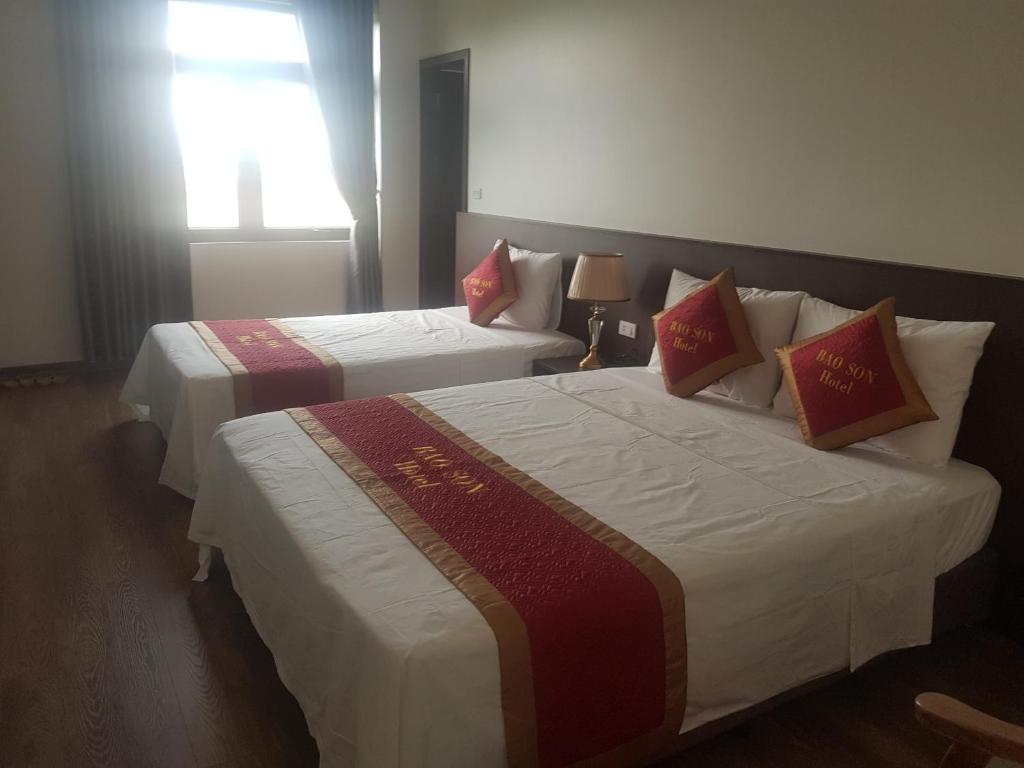 Làng ThànhKhách sạn Bảo Sơn Bắc Giang的配有窗户的酒店客房内的两张床