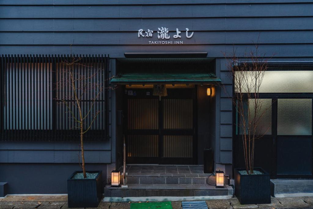 本宫Guest House Takiyoshi的餐厅的前门,有两棵盆栽树木