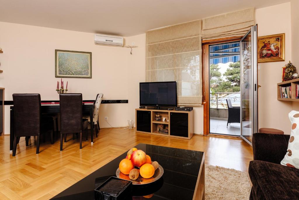 蒂瓦特Apartment Sahala的客厅配有桌子和电视