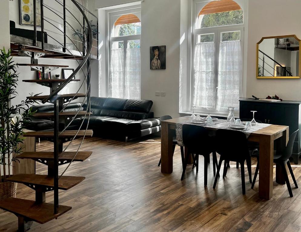 罗韦雷托Ca’ dei Cigni的一间带桌子和螺旋楼梯的客厅
