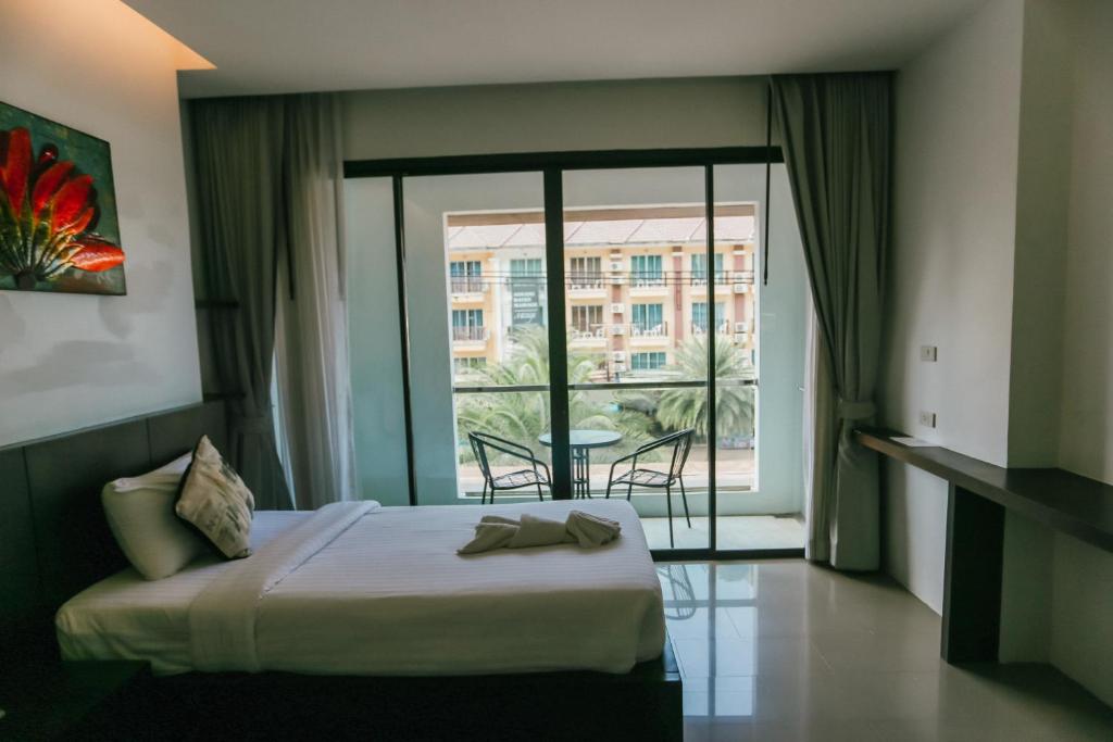奥南海滩Phranang Place- SHA Extra的酒店客房设有一张床和一个大窗户
