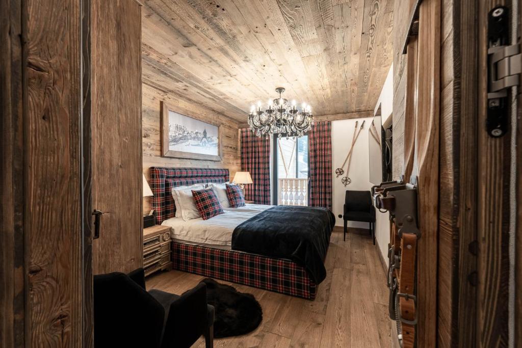 卡纳泽伊Belvedere Elite的一间卧室配有一张床和一个吊灯