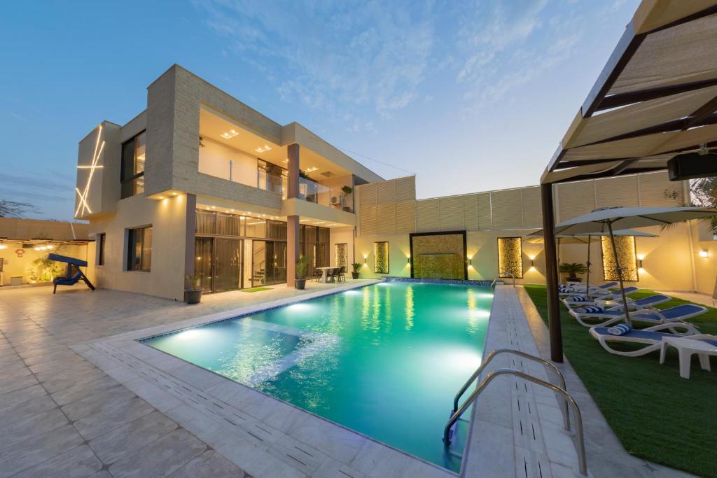 索瓦马Adam's Luxury Villa DeadSea的房屋前的游泳池
